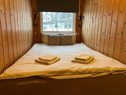 a bed in a room with two towels on it at Apartment Grønlid in Rauland