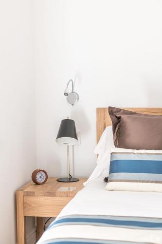 a bedroom with a bed and a table with a lamp at Bordoy Mostatxins - Hotel Boutique Adults Only in Alcudia