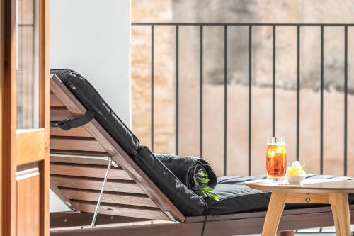 a hammock on a balcony with a table at Bordoy Mostatxins - Hotel Boutique Adults Only in Alcudia