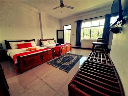 a bedroom with a bed and a desk and a window at Royal Bath Edge in Kandy