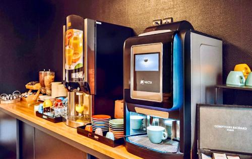 a coffee machine sitting on a counter in a room at Tulip Inn Honfleur Residence & Spa in Honfleur