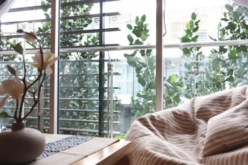 a living room with a couch and a large window at Homesuite' Home at Aeropod SOVO in Kota Kinabalu