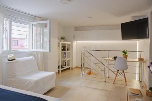 Televízia a/alebo spoločenská miestnosť v ubytovaní Larios Premium Apartments