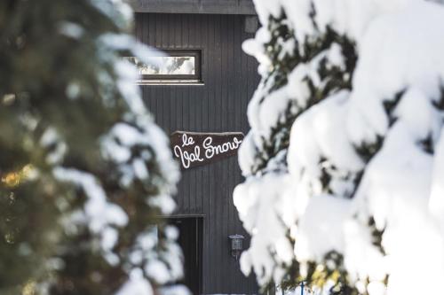 a black door with a sign on it in the snow at Appartement Uccelli - Cocoon just a stone's throw from the centre of Megève in Megève