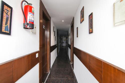 a hallway with a fire extinguisher on the wall at Hotel The Premium Villa in New Delhi