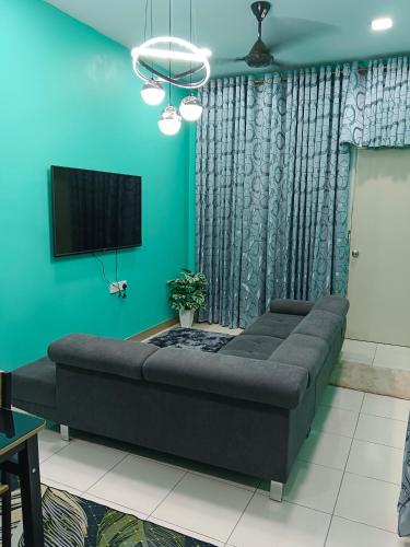 a large bed in a room with a green wall at AISY HOMESTAY KULIM/LUNAS in Kulim