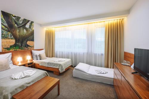Postel nebo postele na pokoji v ubytování Hotel Janosik