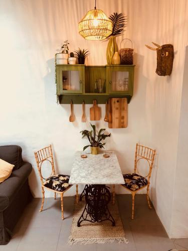 a living room with a table and two chairs at Cuarto Botánico Studio - Shared Pool - Central Island Location - 10 mins drive to Famara and La Santa in Tiagua