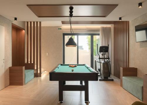a living room with a pool table in it at Amphi Exclusive Residence in Somatás