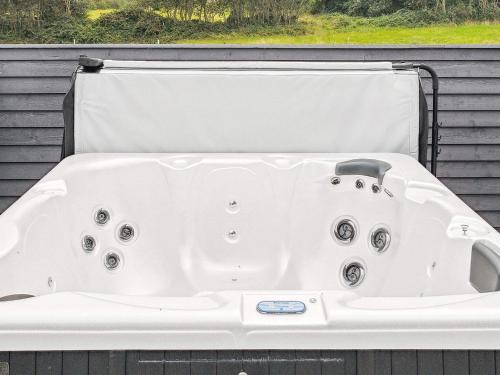 a white bath tub sitting in front of a window at Luxury Family Retreat - By Traum Ferienwohnungen in Børkop