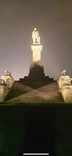 a statue sitting on top of a staircase at Two the Manor Born 3 bedroom house in Tynemouth