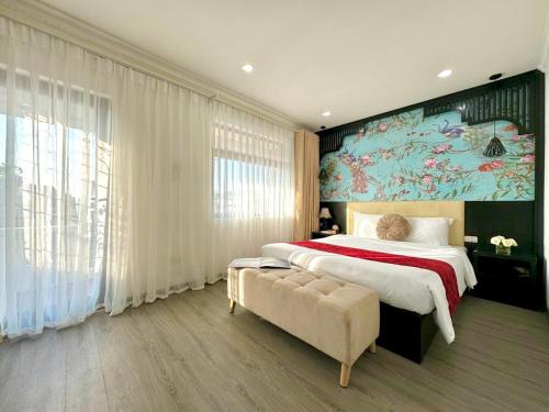 a bedroom with a large bed and a large painting at Hanoi Elpis Hotel in Hanoi