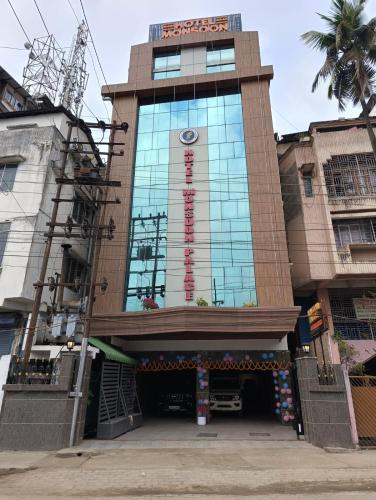a building with a sign on the side of it at Hotel Monsoon Palace Guwahati in Guwahati
