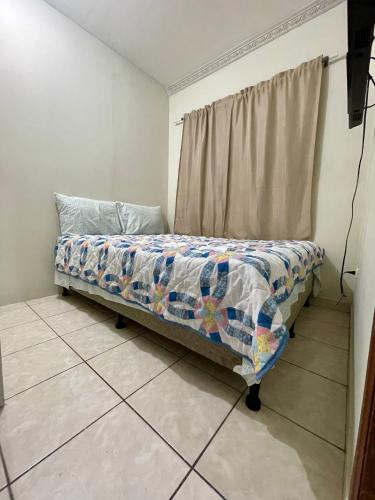 Bett in einem Zimmer mit Vorhang in der Unterkunft Paty’s house in San Pedro Sula