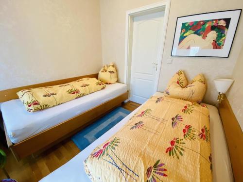 a bedroom with two beds and a window at Haus Louise/Sternenblick in Warnemünde