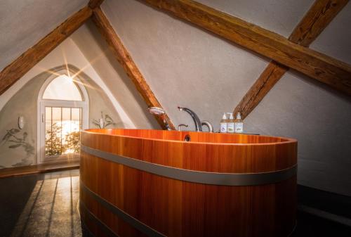 a bathroom with a wooden tub in a room at SeeHotel Amtshof in Langenargen