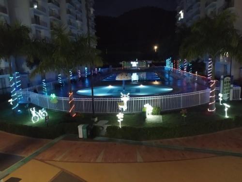 a large pool with lights around it at night at Aqualina Green Girardot in Girardot