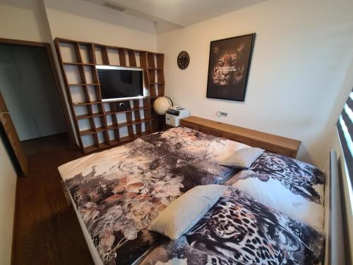 a bedroom with a large bed and a television at Luxury rooftop appartment with fantastic views in Prague