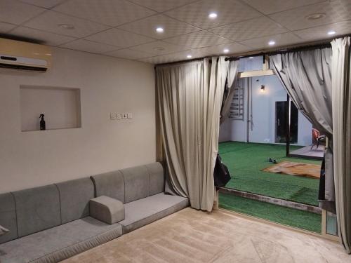a living room with a couch and a green carpet at استراحة المهند in Al-Salam
