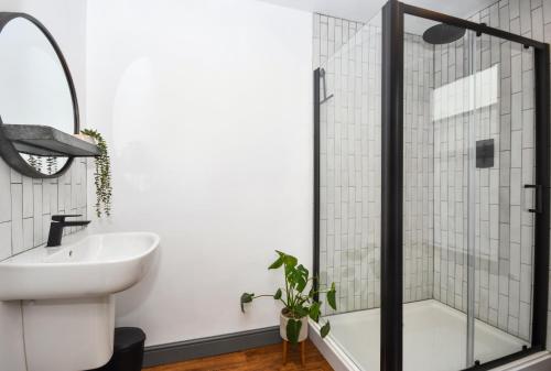 a bathroom with a glass shower and a sink at The Cranny 2 Bed House in Central Morpeth in Morpeth