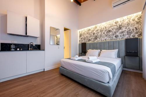 a bedroom with a large bed in a room at Kriel Suites by LIV Homes in Athens