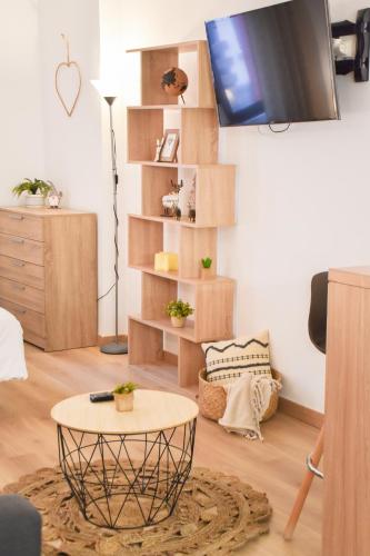 a living room with a table and a tv at La Neu I Studio Pas de Casa HUT2-8055 in Pas de la Casa