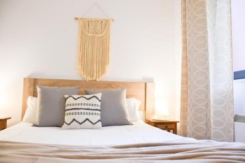a bedroom with a large white bed with pillows at La Neu I Studio Pas de Casa HUT2-8055 in Pas de la Casa