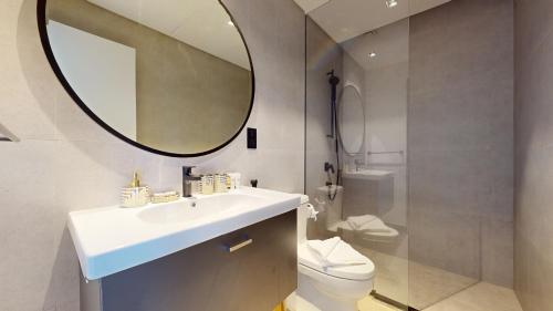 a bathroom with a sink and a mirror and a toilet at Primestay - 15 Northside 2BR in Business Bay in Dubai