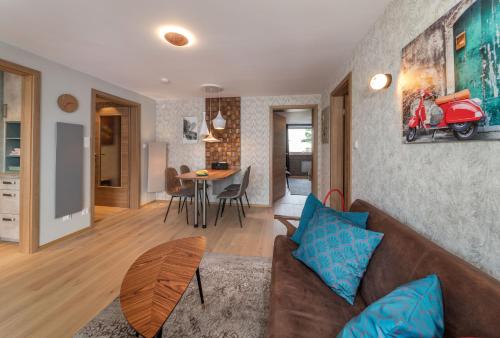 a living room with a couch and a table with a motorcycle on the wall at 2BR-Apartment in Herzogenaurach in Herzogenaurach