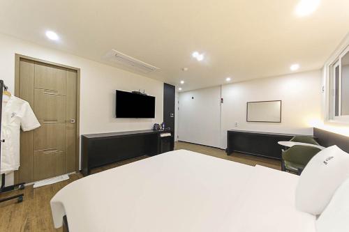 a hotel room with a bed and a tv at Busan Seomyeon Broa Hotel in Busan