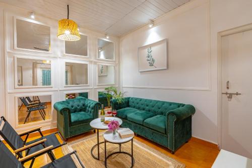 a living room with a green couch and a table at Whoopers Party Hostel, Palolem in Palolem