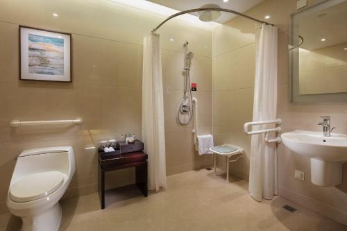 a bathroom with a toilet and a sink and a shower at DoubleTree by Hilton Hangzhou East in Hangzhou