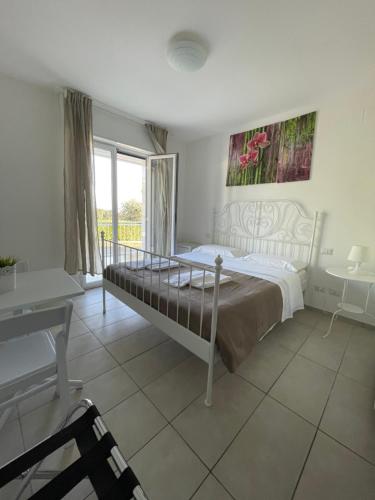 a bedroom with a bed and a desk and a window at Zia Bi Bed and Breakfast in Naples