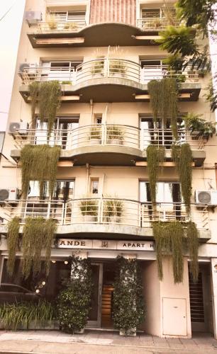 a building with plants on the side of it at Apart Hotel Rio Grande in Rosario