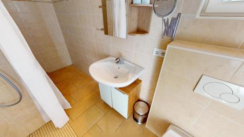 een kleine badkamer met een wastafel en een toilet bij Feriendorf Südstrand Haus 21 in Pelzerhaken