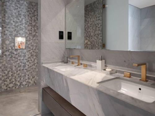 a bathroom with two sinks and a large mirror at FIVE Palm Residences in Dubai