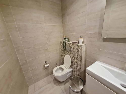 a bathroom with a toilet and a sink at 223 Beacon Rock - 3 Bedroom in Durban