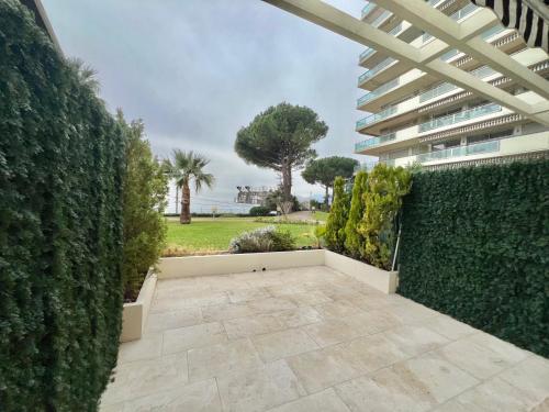 a patio with a hedge and a building at Château de la mer, by Welcome to Cannes in Cannes