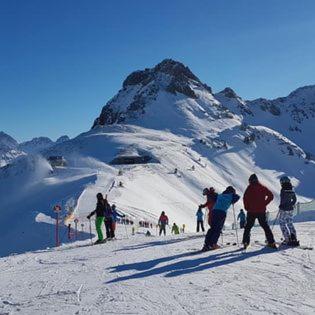 a group of people standing on a snow covered mountain at Appartement 412 Kunners Oostenrijk in Mittelberg