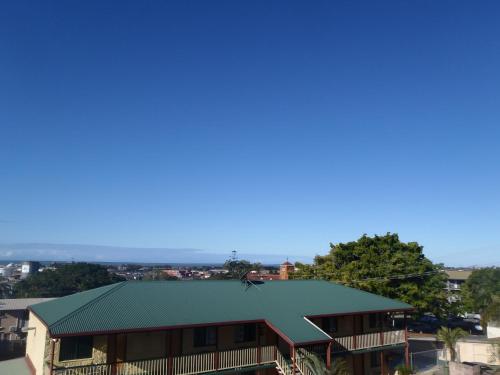 a view of a building with a green roof at Harbour Lodge Motel in Gladstone