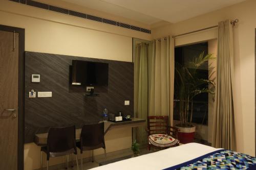 Ένα ή περισσότερα κρεβάτια σε δωμάτιο στο Hotel Pinaka Inn