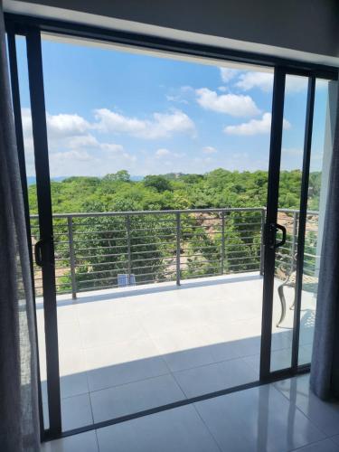 a view from a glass door of a balcony at La Chambre Manor House in Nelspruit