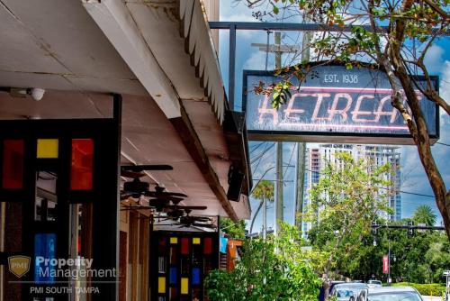 a sign for a store on the side of a street at Dead Poets Society- U of Tampa Flat in N Hyde Park in Tampa