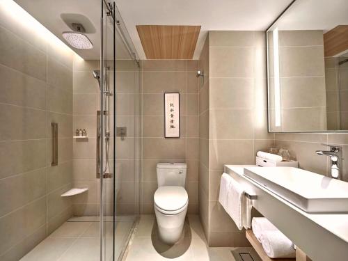 a bathroom with a toilet and a sink and a shower at Hilton Garden Inn Guangzhou Tianhe-Free Shuttle Bus and Buyer Registration Available during Canton Fair Period in Guangzhou