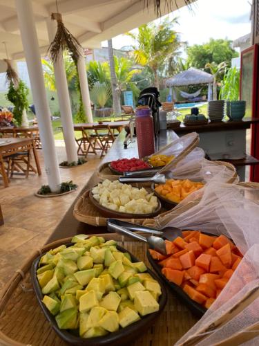 a buffet of different types of fruits on a table at Pousada Bate Vento in Itarema