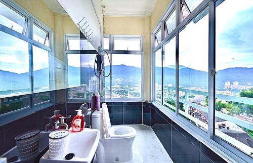a bathroom with a sink and windows with a view at Penang Dream Banglo Sleeps 28 in Tanjung Bungah