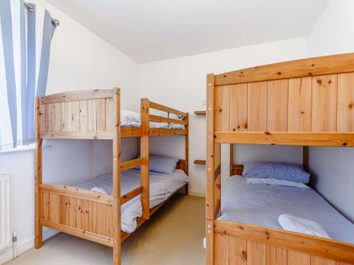 a bedroom with two bunk beds and a window at 3 Bed in Torquay 82959 in Torquay