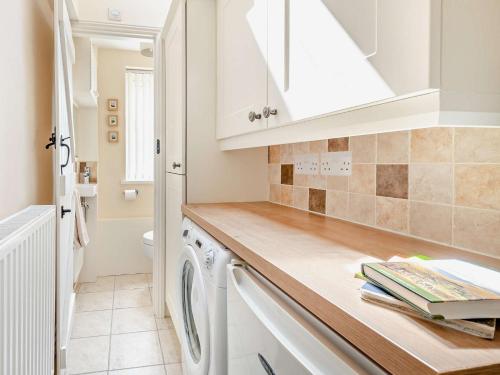 a white kitchen with a washer and dryer at 2 bed in Shap SZ005 in Shap