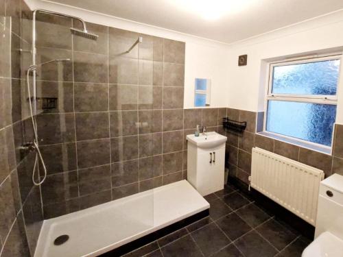 a bathroom with a shower and a toilet and a sink at 3 bed property in Swansea South Wales 83479 