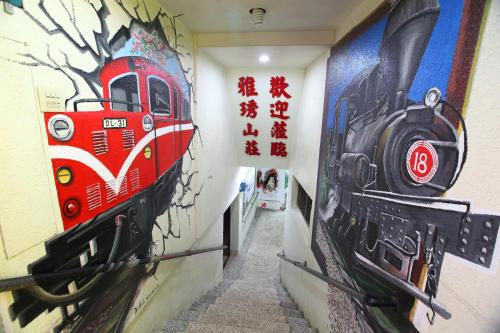 a hallway with a painting of a train on the wall at Yeashow Villa in Fenchihu